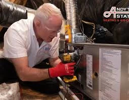 Heating technician servicing a furnace with a test meter